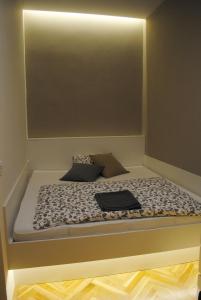 a bed with a laptop on top of it at Apartments Centre in Style in Olomouc +21 photos