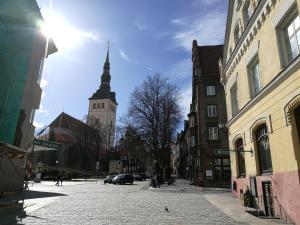 a city street with a clock tower in the background at Old Town Niguliste Residence in Tallinn