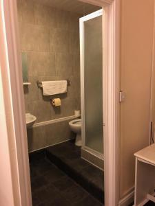 a bathroom with a toilet and a sink at Station Inn in Hexham