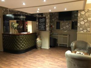 a lobby with a bar and chairs in a store at Station Inn in Hexham
