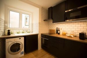 a kitchen with a washing machine and a sink at Olá Lisbon - Chiado III in Lisbon