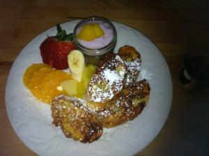 a plate of food with fruit on a table at Paola Beauty Farm B&B and Day Spa in Dalroy