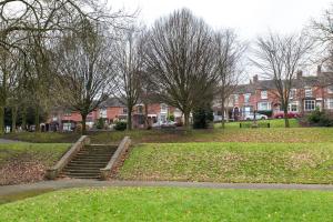 a park with stairs and trees and houses at Northwood Park View in Stoke on Trent