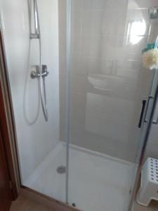 a shower with a glass door in a bathroom at Largo do cruzeiro in Póvoa de Varzim