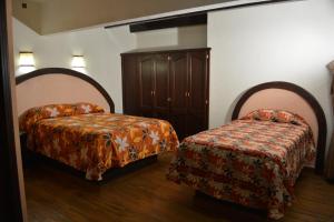 Postel nebo postele na pokoji v ubytování Hotel Barroco