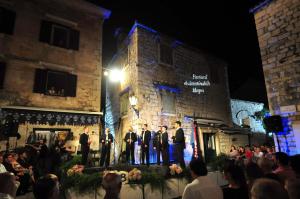 a group of men standing on a stage in front of a building at Apartment Mimica-Croatia , Omis , Center in Omiš