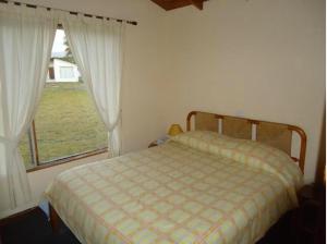 a bedroom with a bed and a large window at Cabañas 4 Esquinas in La Serena +38 photos