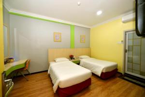 Classic Boutique Hotel Kuantan客房内的一张或多张床位