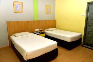 Classic Boutique Hotel Kuantan客房内的一张或多张床位