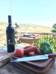 a cutting board with vegetables and a bottle of wine at The Cave Of Wine by Casavino in Casablanca