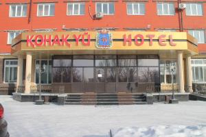 a hotel with a sign on the front of it at Semey Hotel in Semey
