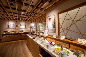 a restaurant with a counter with food on it at Hotel Miyajima Villa in Miyajima +91 photos