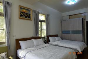 Postel nebo postele na pokoji v ubytování Fu Courtyard Homestay