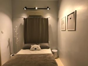a bedroom with a bed with a pillow on it at beNordic -8-10mins Tambun Water Park-10-14Pax in Ipoh