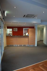 a lobby with a reception desk in a building at Madison Tower Mill Hotel in Brisbane