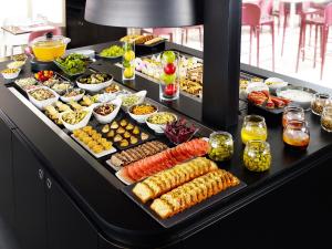 a buffet with many different types of food on it at Campanile Lens in Lens