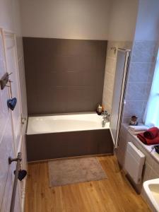 a bathroom with a bath tub and a sink at Manoir Tregont Mab in Quimper