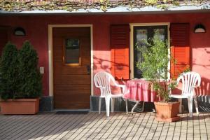 two chairs and a table in front of a house at Ca di Stremb in Maggia