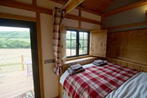 a bedroom with a bed and a large window at Flying Scotsman in Cray