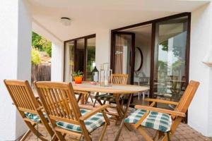 a wooden table and chairs on a patio at Ferienwohnung Raina in Bad Säckingen
