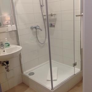 una doccia con una porta in vetro accanto a un lavandino di Haus am Karpfenteich a Hahnenklee-Bockswiese