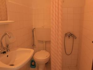 a bathroom with a toilet and a sink and a shower at Rent Rooms Katerina in Kalamaki Heraklion