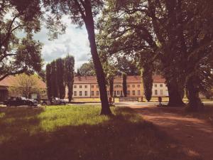a large building with trees in front of it at Landhaus Arcadia in Paretz in Ketzin