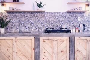 a kitchen with wooden cabinets and a counter top at Samstay in Tuy Hoa