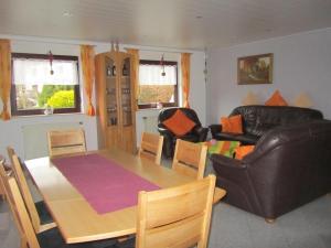 a living room with a table and a couch at Ferienhaus Wunsch in Oberkirch