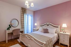 a bedroom with a large white bed and a mirror at Villa Sea Breeze in Split +38 photos