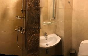 a bathroom with a sink and a shower at Non-stop Economy hotel in Boryspilʼ