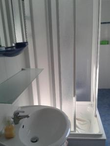 a bathroom with a white sink and a shower at Apartments zum Brauergang in Garz +19 photos