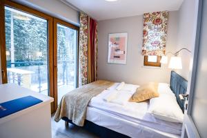 Кровать или кровати в номере Apartamenty Sun & Snow Bukowa Dolina