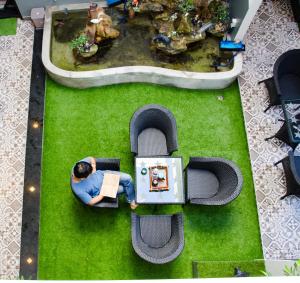 an overhead view of a man in a toy car in a park at La Me Villa Hoi An in Hoi An