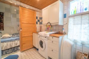 a laundry room with a washer and dryer at Oak House in Naantali