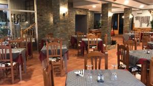 - un restaurant avec des tables et des chaises dans une salle dans l'établissement Hostal Venta del Peral, à Cúllar de Baza