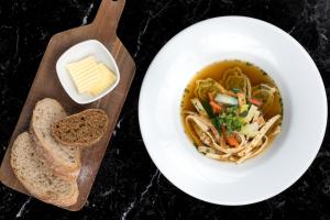 a bowl of soup with bread and a bowl of butter at Wyndham Stuttgart Airport Messe in Stuttgart