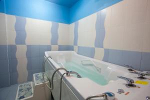 a bathroom with a sink and a bath tub at Balneo & SPA Hotel Aura in Velingrad