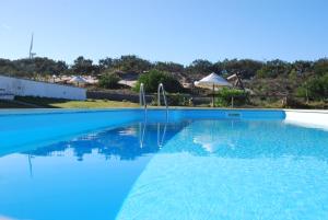 a swimming pool with blue water at Quinta da Falca in Nazaré