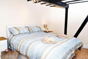 a bedroom with a large bed with towels on it at Wrenbury Mill Apartment in Wrenbury