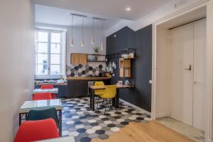 a kitchen with a table and chairs in a room at Napoliamo Guest House in Naples