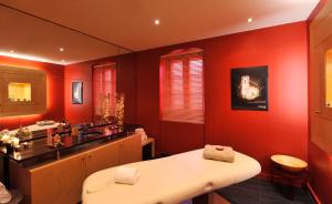 a red bathroom with a sink and a toilet at Cottages De La Bretesche in Missillac +27 photos