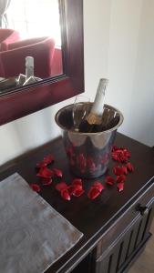 a bottle of wine sitting on top of a table at Tava Lingwe Game Lodge & Wedding Venue in Parys