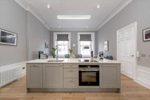 a large kitchen with a sink and a stove at ALTIDO Spacious and Bright 1bed Apt, short walk from Princes street in Edinburgh