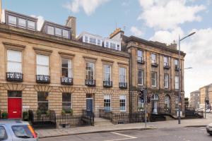 a large brick building on the corner of a street at JOIVY Spacious and Bright 1bed Apt, short walk from Princes street in Edinburgh