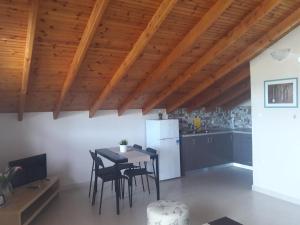a kitchen and dining room with a table and chairs at Villa Eleni in Ofrínion