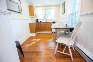 a kitchen with a table and chairs in a room at Gay Street Inn in Washington, Virginia
