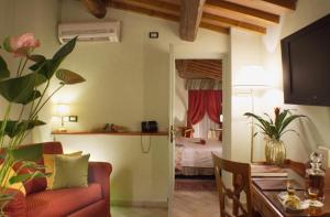 a living room with a couch and a bedroom at JOIVY Together Florence Secret Nest in Florence