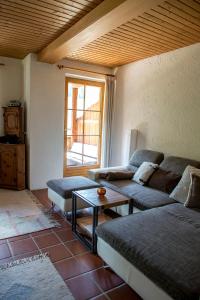 a living room with two couches and a table at FEWO Silberberg TOP 4 in Alpbach