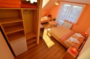 a small room with a bed and a window at Penzión Family Rušin in Veľká Lomnica